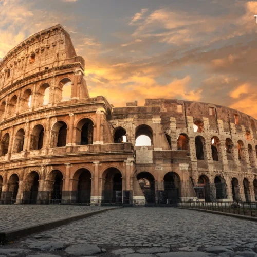 Sun shining brightly through the ancient stone arches of the Colosseum in Rome, Italy.