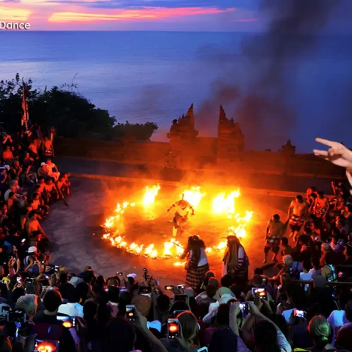 Traditional Balinese Kecak fire dance performance at Uluwatu Temple during sunset.