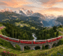 Palatial historic resort architecture and scenic frozen alpine landscapes in St. Moritz, Switzerland, an elite international holiday destination designed by Findholidays travel agency in Chennai.