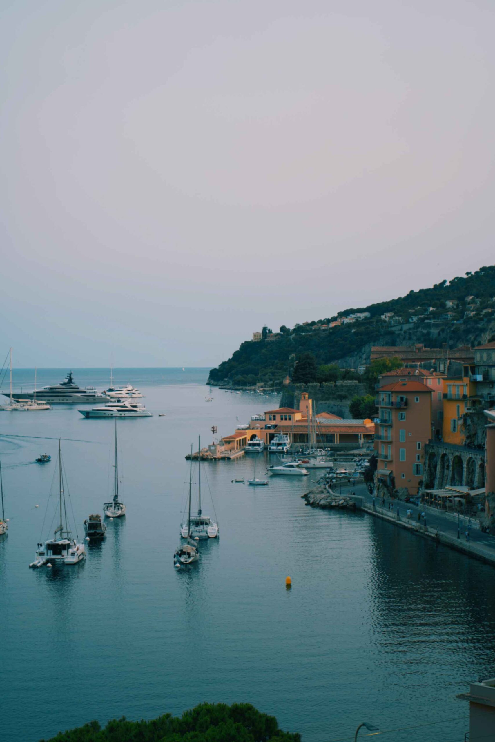 Luxury sleek white yacht moored in Cannes marina near La Croisette booked via Findholidays