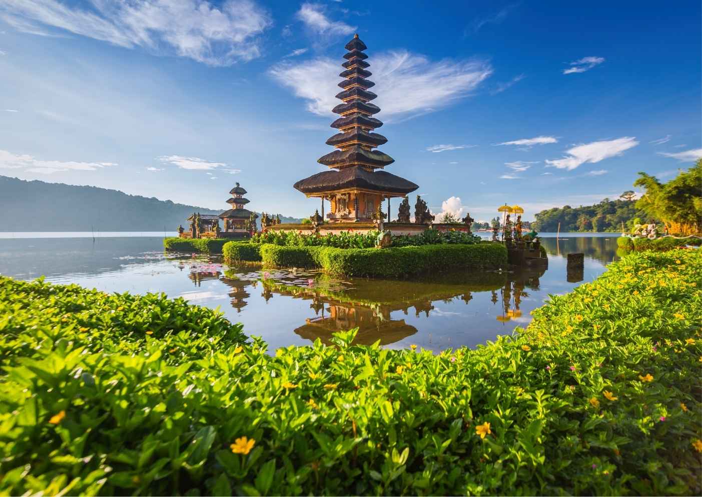 Tanah Lot Temple in Bali during a dramatic sunset near the ocean