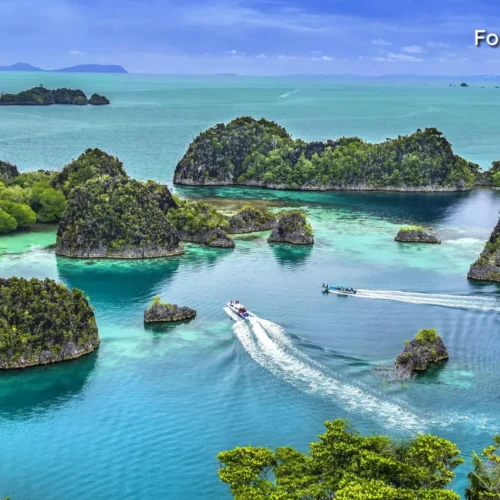 Speedboat cruising through the turquoise waters of the An Thoi Archipelago.