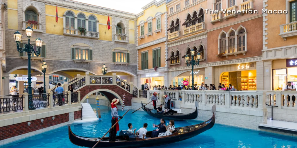 Traditional gondolas floating on the Venice-inspired indoor canals inside The Venetian Macao luxury resort.