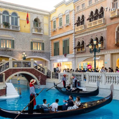 Traditional gondolas floating on the Venice-inspired indoor canals inside The Venetian Macao luxury resort.