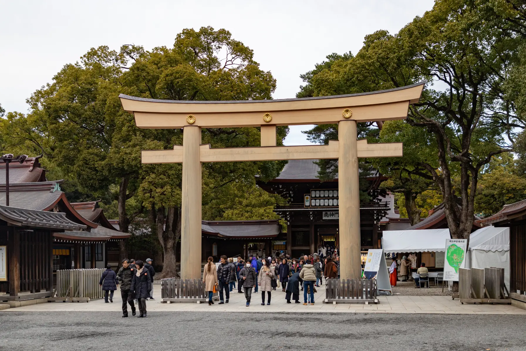 Towering cypress wood torii gate and sacred sake barrels at Meiji Jingu Shrine and Shinjuku Gyoen in Tokyo