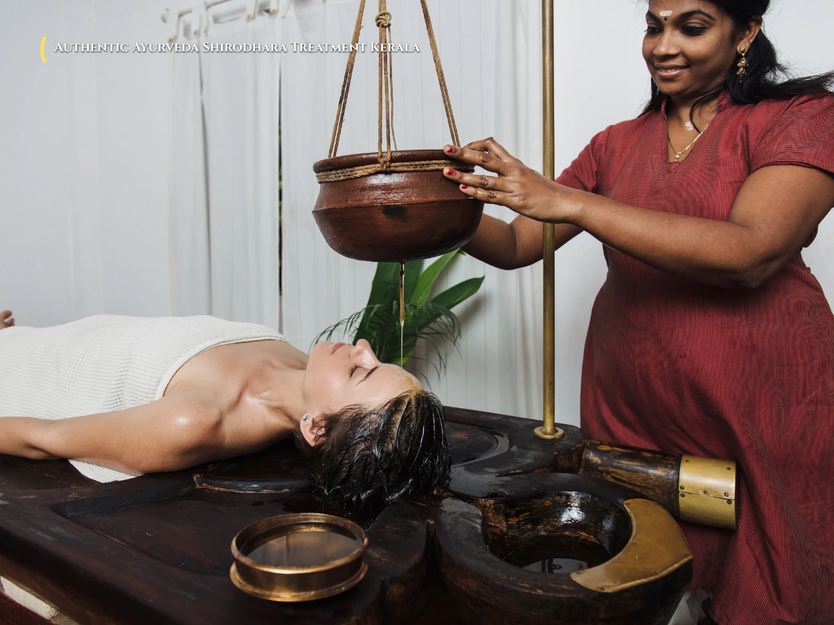 Traditional Shirodhara warm herbal oil treatment in an authentic Ayurvedic wooden treatment chamber in Kerala
