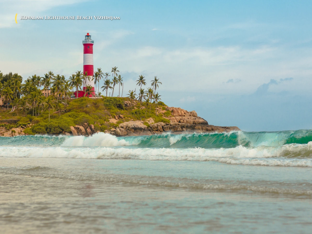 Red and white striped Vizhinjam Lighthouse standing at the rocky headland of Lighthouse Beach in Kovalam Kerala