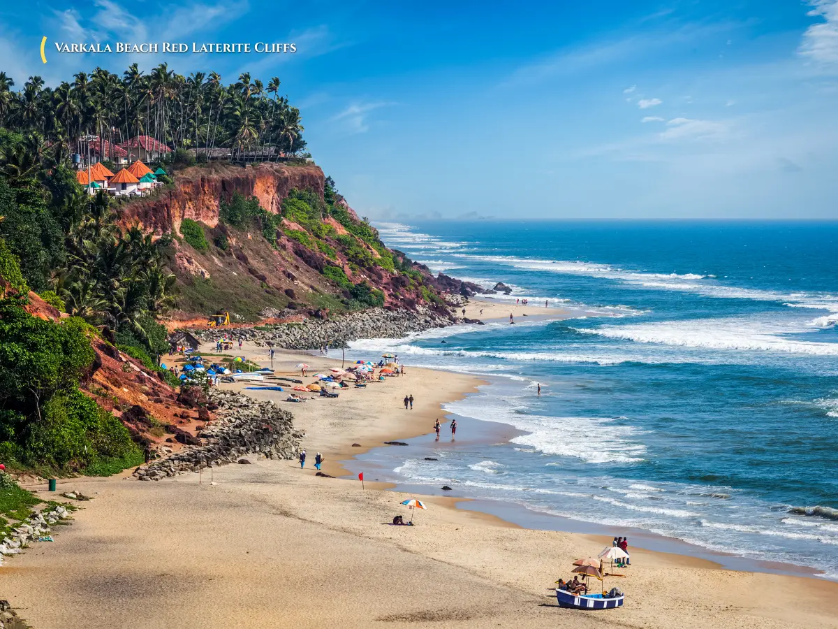 Red laterite coastal cliffs overlooking the Arabian Sea at Varkala Papanasam Beach Kerala with sunset glow
