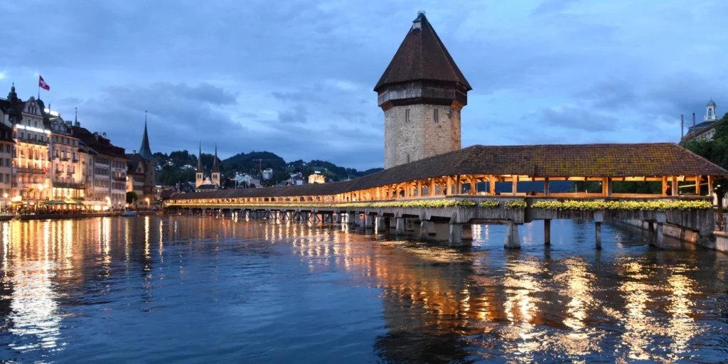Historic wooden Chapel Bridge and Water Tower across the Reuss River in Lucerne, Switzerland.