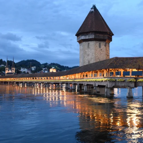 Historic wooden Chapel Bridge and Water Tower across the Reuss River in Lucerne, Switzerland.